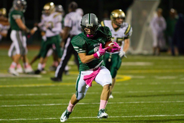 Skyline's Eric Thies hauls in a long pass reception in the third quarter. Spartan players wore pink socks