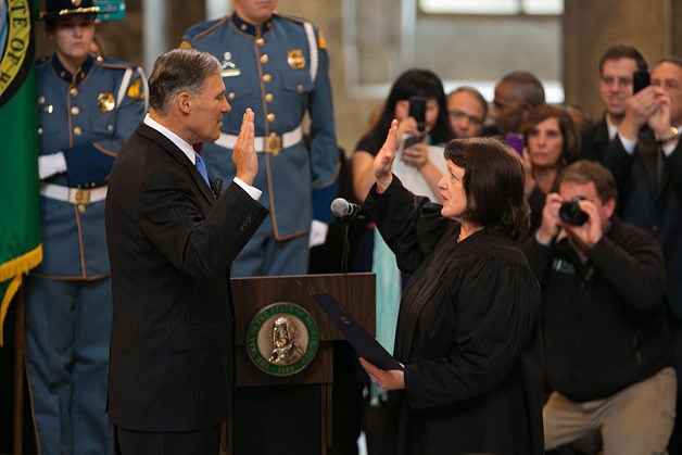 Washington State Supreme Court Chief Justice Barbara Madsen administers the oath of office to Governor Jay Inslee in the Olympia Capitol rotunda Wednesday.