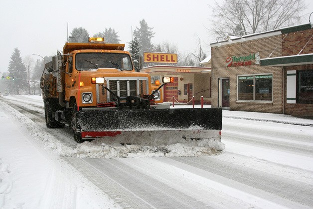 Mark Barfield plows Front Street with a dump truck modified for the weather. While most of Issaquah stayed home Wednesday