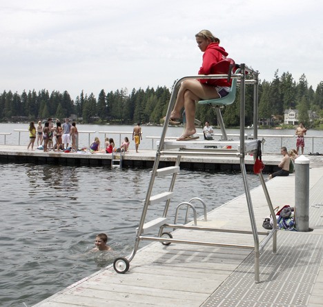 Lifeguard Kalla Klien keeps swimmers in line at Pine Lake on Wednesday