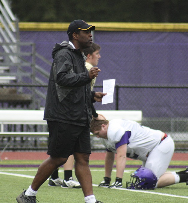Issaquah head coach Buddy Bland walks the field before one of his team's spring practices