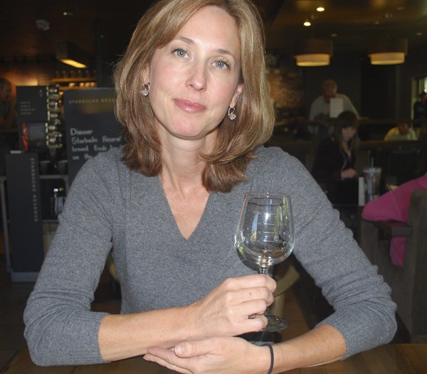 Laura Dale holds one of the calorie-counting wine glasses.
