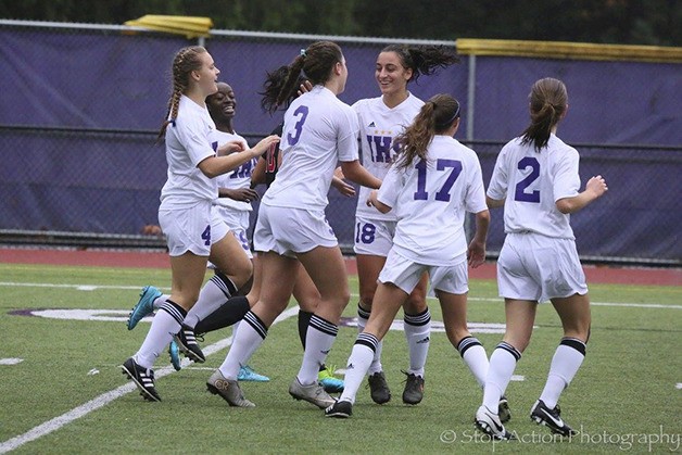 The Issaquah Eagles girls soccer team celebrates after scoring a goal in the first half of play against the Union Titans. Issaquah defeated Union 5-0
