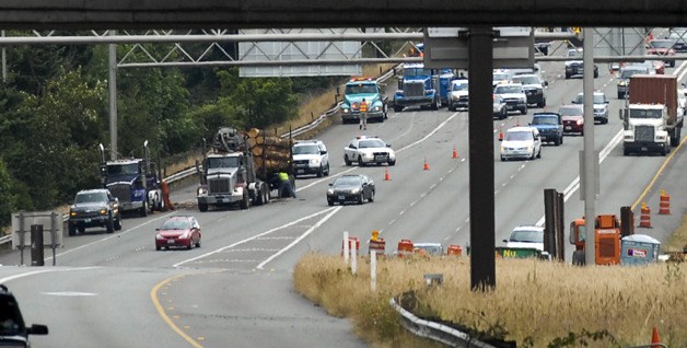 Crews work to clean up the aftermath of a 15-vehicle wreck on I-90 on Wednesday morning that sent seven people to hospitals.