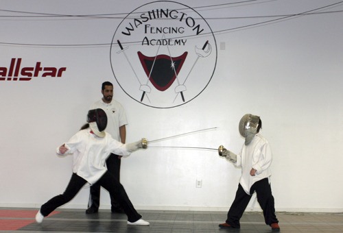 Eugenio Salas teaches two beginning fencers the basics at the Washington Fencing Academy. The academy