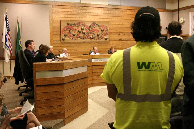 Waste Management employees packed city hall Monday night to challenge a recommendation to switch garbage collectors to Cleanscapes.