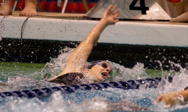 Skyline's Katie Kinnear reaches for the wall in the 100 backstroke. She claimed her first state title in the event and seventh overall individual title in an automatic all-American time of 54.60.