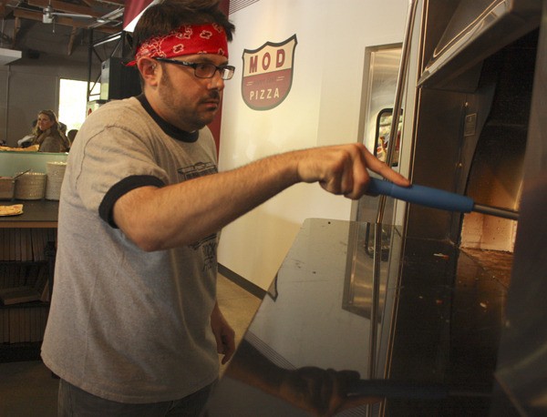Store manager Anthony Ferrara works at the MOD oven