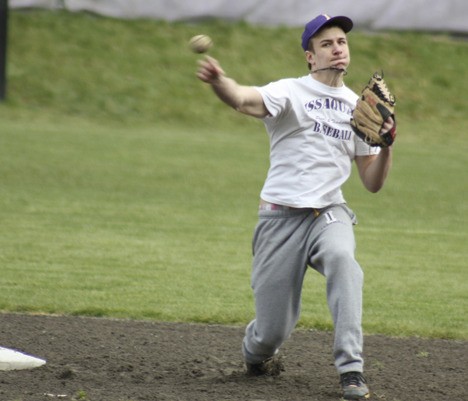 Issaquah second baseman Gavin Schumaker launches a throw to first base during practice.