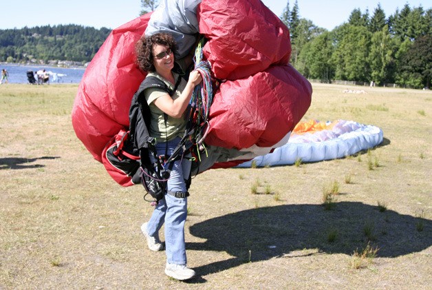 Tisha White practices ground maneuvers with her paraglider at Lake Sammamish State Park. She doesn't mind the state's new access fees for state parks