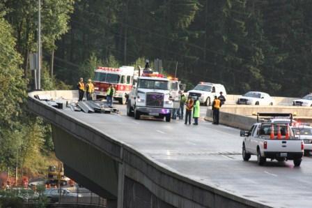I-beams lay scattered across the Highlands Drive exit of I-90 after a truck overturned during the evening commute on Tuesday.