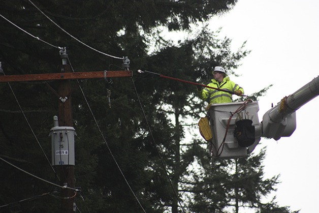 A worker repairs a power pole on Southeast 20th Street Thursday afternoon.