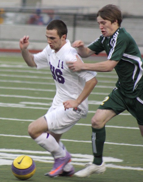Issaquah's Michael Axelson tussles with Redmond's Sean Cooley Tuesday night at IHS.