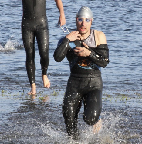 Triathletes exit the water during the first leg of the Issaquah Triathlon.