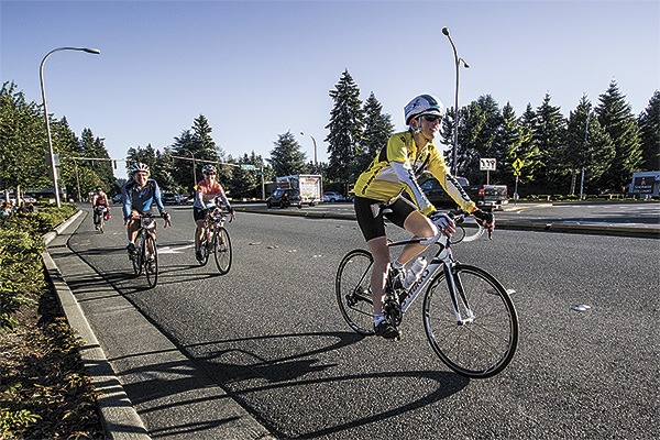 Riders pass by a rest stop in Redmond during the seventh annual 'Cycle the WAVE' fundraising and awareness rally for domestic violence.