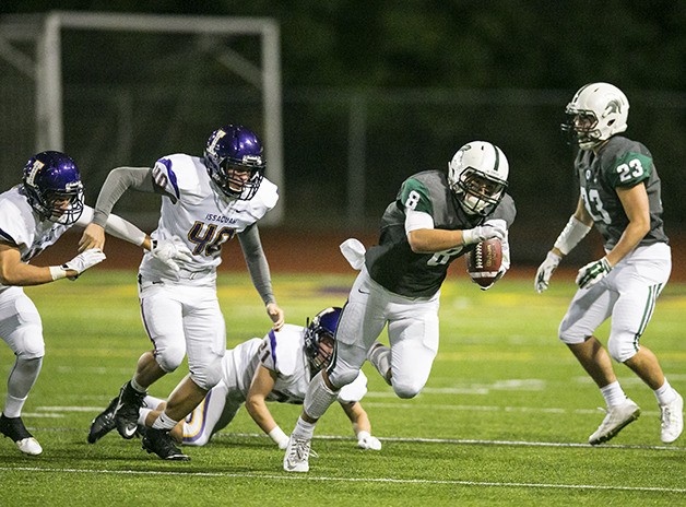 Skyline wide receiver Bradley Kim breaks free into the Issaquah secondary after catching a pass from quarterback Blake Gregory. The Spartans trailed the Eagles 28-14 with 9:29 left in the fourth quarter but outscored Issaquah 17-0 down the stretch to capture a victory. Skyline kicker Jack Crane connected with a 44-yard field goal in overtime