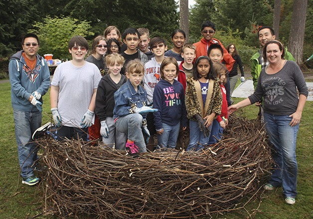 Children stand in a nest they constructed in Lower Sammamish Commons Park Saturday morning.