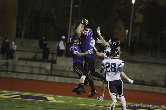 Issaquah cornerback Conner Pederson intercepts Olympia quarterback Jack Bell on the final play of the first half. Pederson finished the game with three interceptions.