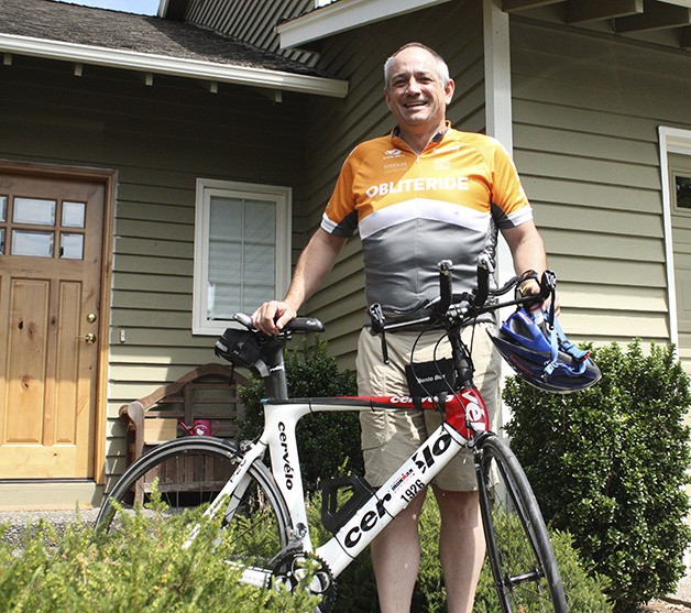 Paul Weigel stands with his bike near his Issaquah home.