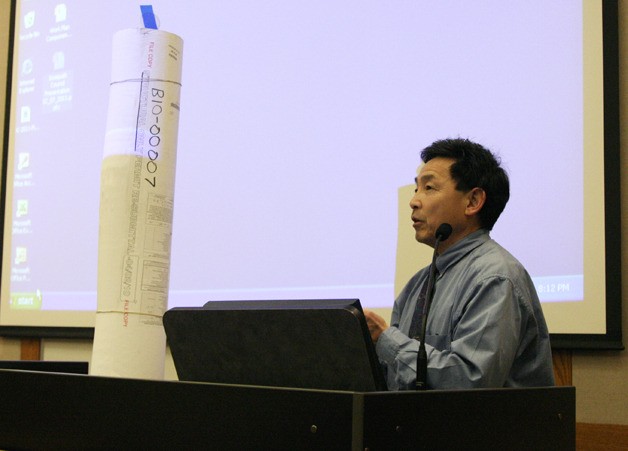 Issaquah building director John Minato presents just one roll of paper plans for the Swedish Medical Center