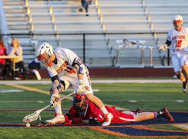 Eastside Catholic sophomore Brennan Cronk regains control of the ball after knocking down a Stanwood player on April 16 at Eastside Catholic High School in Sammamish. Eastside Catholic improved their overall record to 6-1 with the victory.