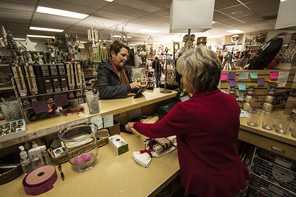 Marilyn Haberlach completes a purchase at Look's Gifts and Card Nov. 13. 10 percent of her purchase is going to LifeWire as part of the shop's 15th annual fundraiser for the domestic violence victim's support charity.