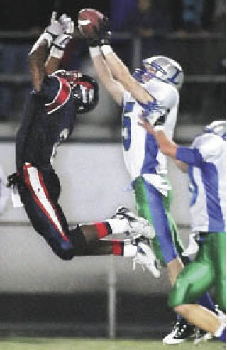 Liberty’s Taylor Hamann intercepts a pass Friday in the waning moments of Liberty’s comeback win at Highline Stadium.