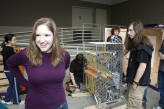 Team President Elyse Edwards poses with the robot built for the 2009 competition season