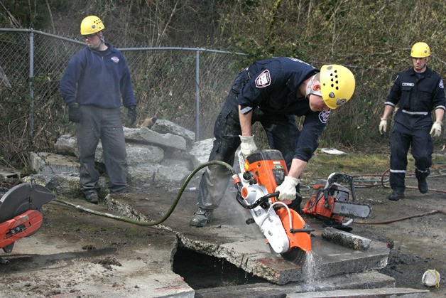 Firefighter Tom Tull uses a water saw during a training session at Eastside Fire and Rescue. EFR received $115
