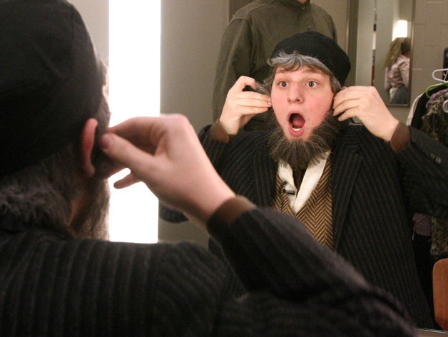 Sam Tacher puts on a beard  for his role as a butcher in Fiddler on the Roof at Issaquah High School. The production was the first to christen the school's new stage.