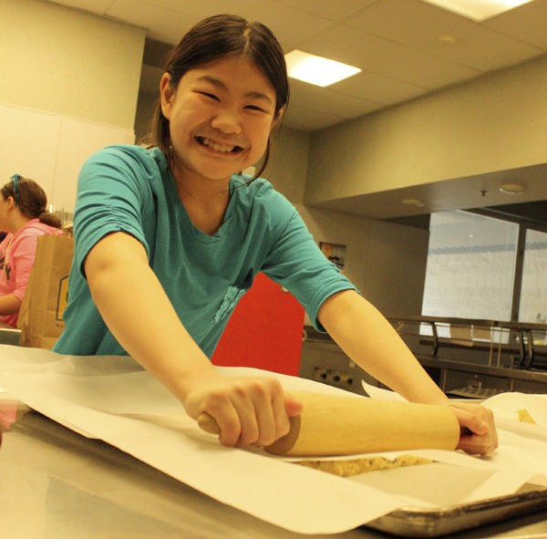 Beaver Lake sixth-grader Cindy Xiao has a blast rolling cookie dough Tuesday doing her part in creating the state's largest known ice cream sandwich.