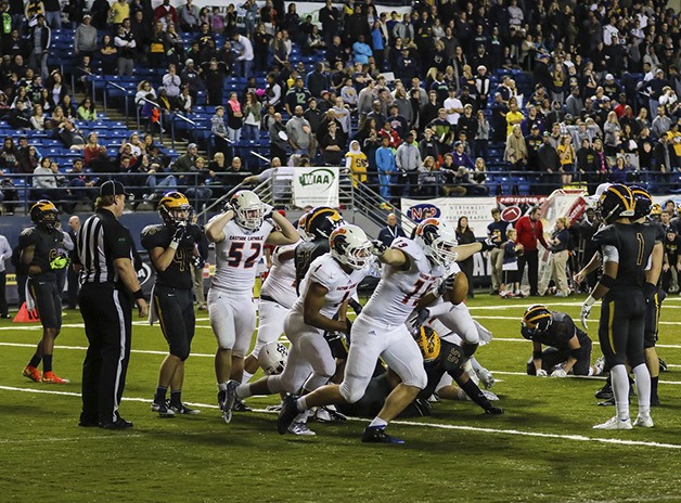Crusaders’ players celebrate after Brandon Wellington scored on a 1-yard run in overtime