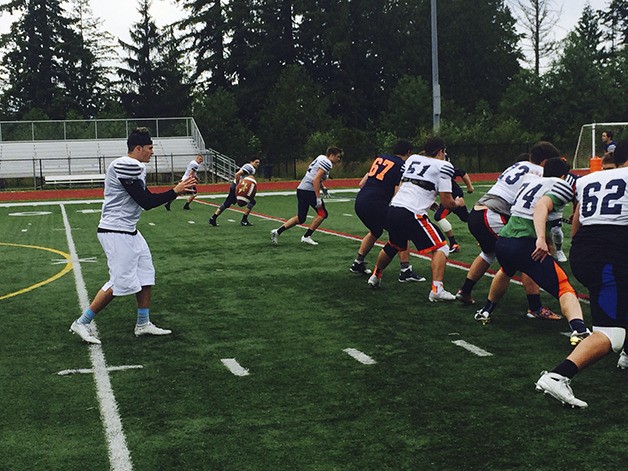 Eastside Catholic Crusaders junior quarterback Zach Lewis takes a snap from center during a spring practice session on June 10 in Sammamish. Lewis was Harley Kirsch's backup the past two seasons.