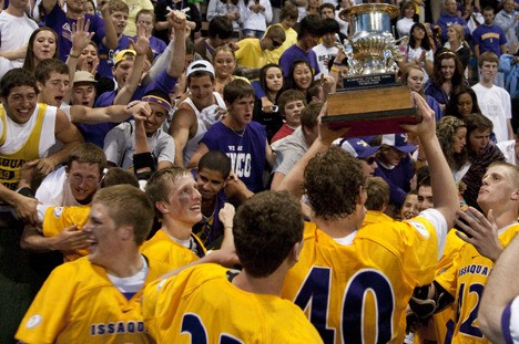 The Issaquah lacrosse team hoists the Division I state championship trophy up after beating Mercer Island