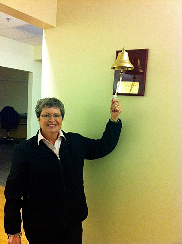 Anita Cox rings one of the bells she donated to Swedish-Issaquah.