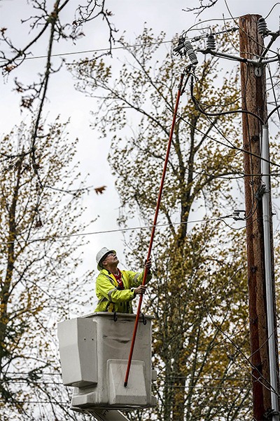 A Puget Sound Energy crew member works to restore power in Sammamish Tuesday.