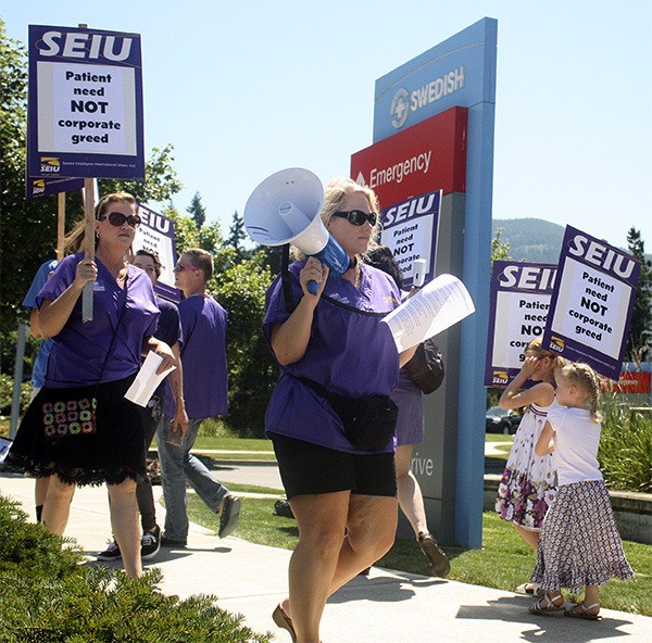 Unionized health care workers picketed outside Swedish Issaquah in July.