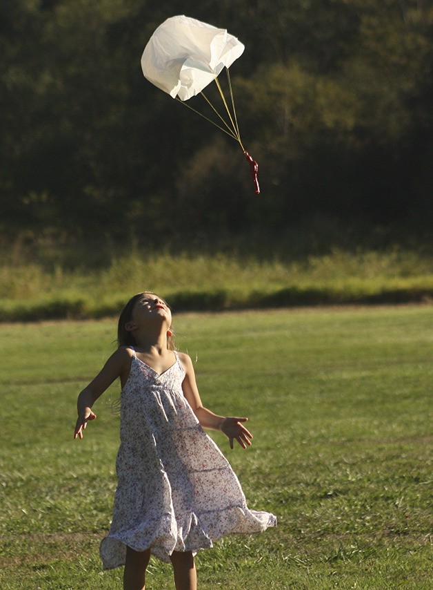 A girl plays with a toy parachutist at the Fantastic Fly-In.