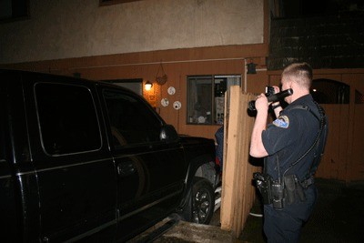Issaquah Police Officer Todd Johnson surveys the damage caused by an alleged drunk driver