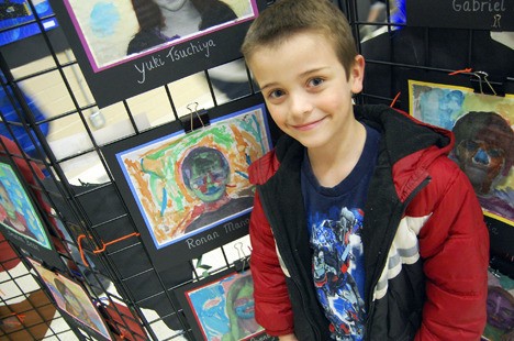 Margaret Mead student Ronan Manoske in front of his self portrait at the school's Art Gallery Night on Thursday.