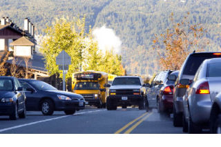 Vehicles come and go from Grand Ridge Elementary school (at left) in the Issaquah Highlands. This photo was taken looking westbound along Northeast Park Drive before school this week. Residents at a meeting last week said they’re concerned further development will worsen the school-area traffic.