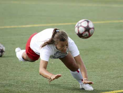 Skyline senior Meighan Hawkes connects with a diving header during practice last week.