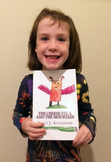 Six-year-old Emily Alexander holds the book she wrote