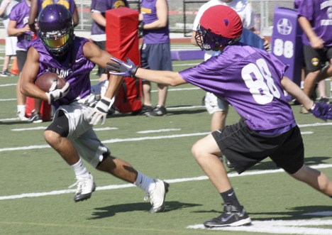 Issaquah wide receiver Adam Dondoyano cuts up field during a passing drill last week.