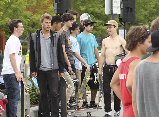 A group of teens waits to get in a practice run at the skate bowl.