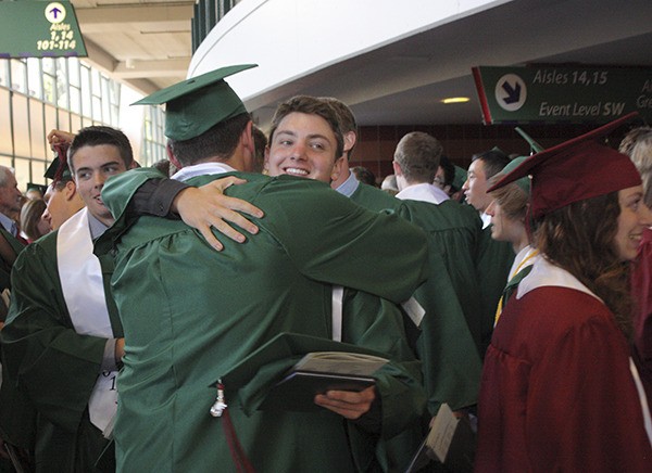Grant Beahm gives a classmate a huge hug Monday after exiting Eastlake's 2013 graduation ceremony at Key Arena.