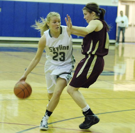 Skyline senior Lindsey Nicholson fends off South Kitsap's Jackie Steiger Friday night at Rogers High School in Puyallup.
