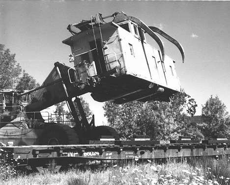 The Issaquah caboose is lifted off its wheels at Vail Camp in 1989 for transport by flat car to Issaquah.