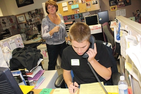 Issaquah High School senior David Erickson makes a call to a potential donor during the calling for kids fundraising campaign.