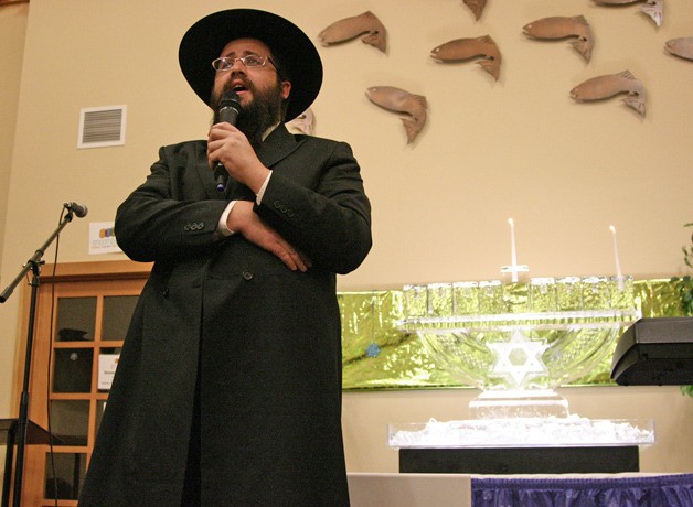 Rabbi Berry Farkash speaks at the annual menorah lighting ceremony on the first night of Hanukkah in the Issaquah Highlands.